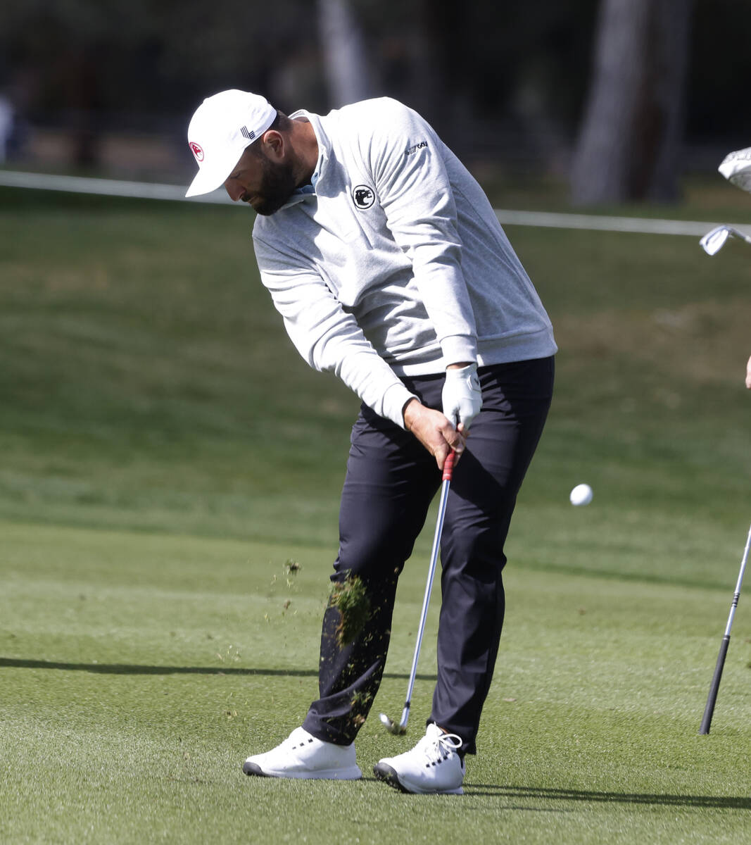 Jon Rahm hits onto the 18th green during LIV Golf Las Vegas Pro-Am tournament at Las Vegas Coun ...