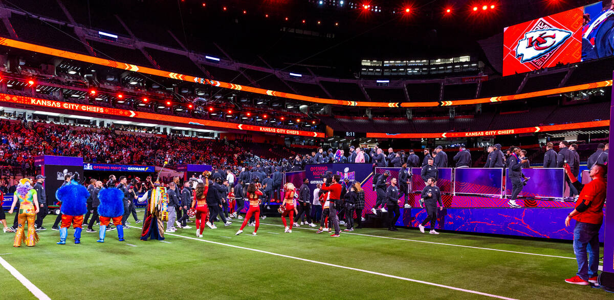 Kansas City Chiefs players and coaches stand before the crowd on the field during the Super Bow ...