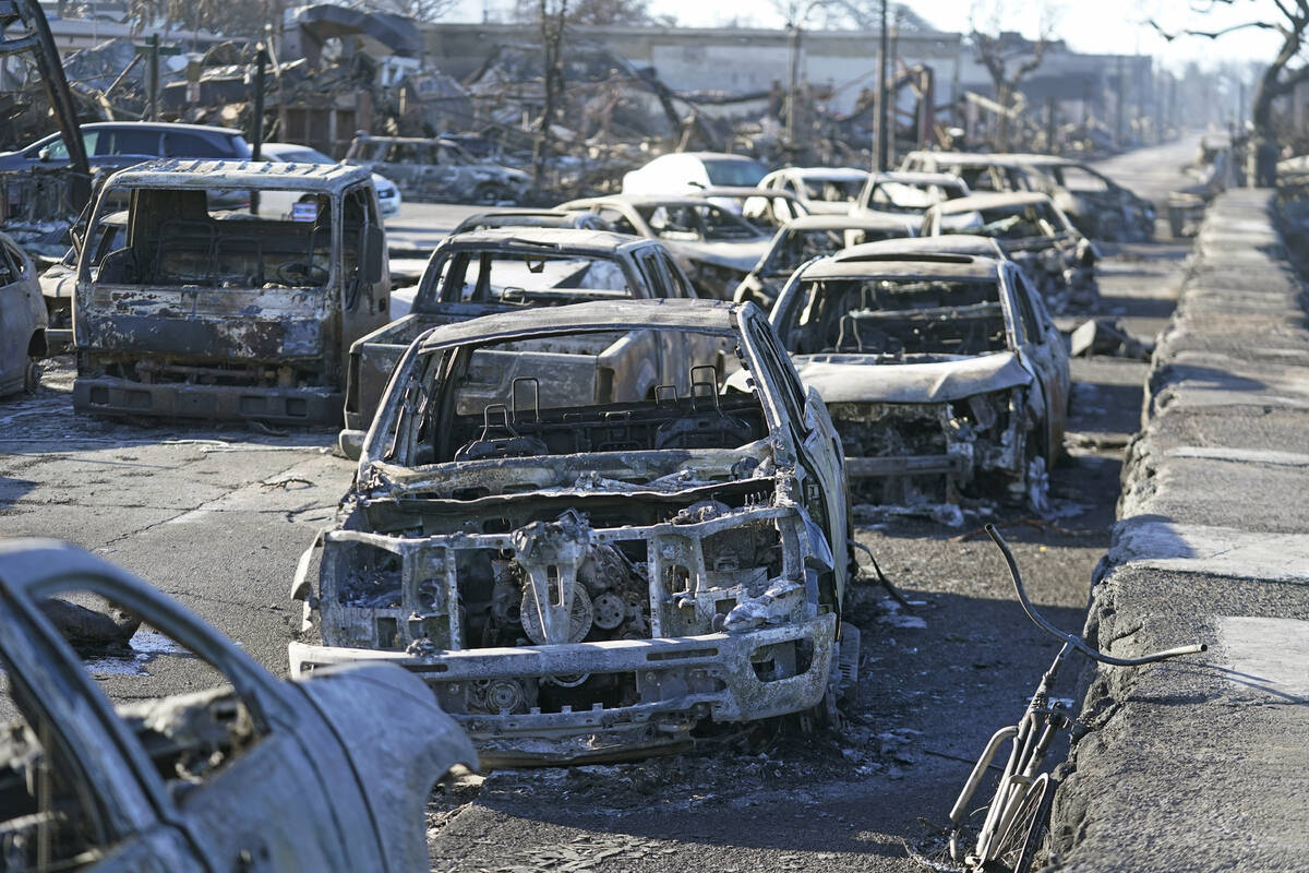 Burnt out cars line the sea walk after the wildfire on Friday, Aug. 11, 2023, in Lahaina, Hawai ...