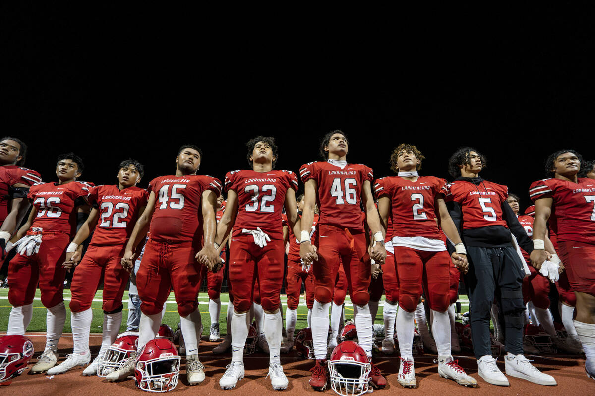 The Lahainaluna High School football team hold hands to thank the fans after a game Saturday, O ...