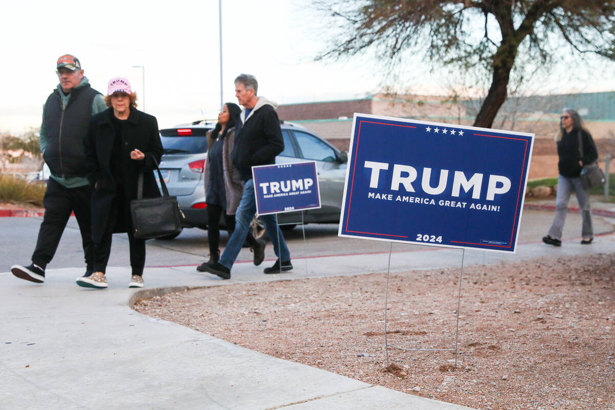 Voters prepare to vote at a caucus center located at Sig Rogich Middle School in Summerlin duri ...