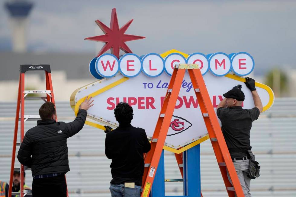 Workers prepare a welcome to Las Vegas sign in preparation of team arrivals ahead of the NFL Su ...