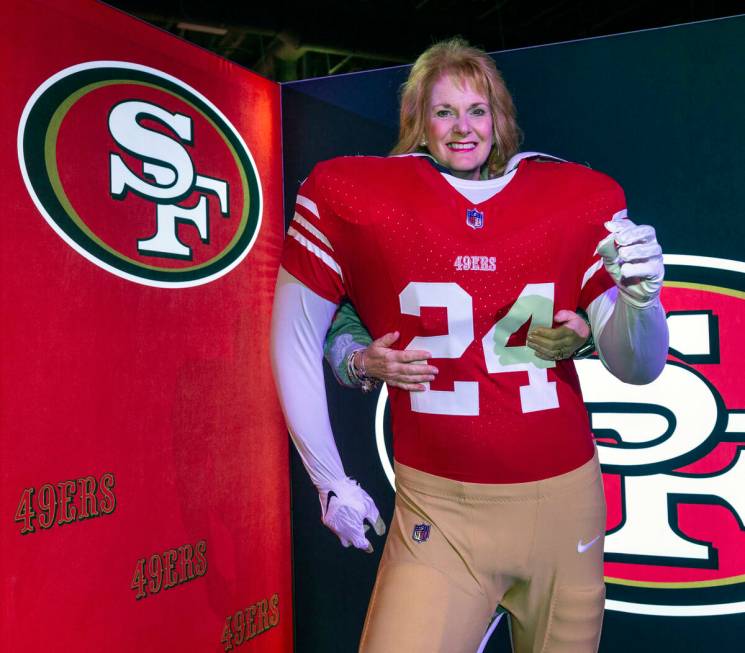 Lynda Scullin of Las Vegas stands behind a San Francisco 49ers player body during the Super Bow ...