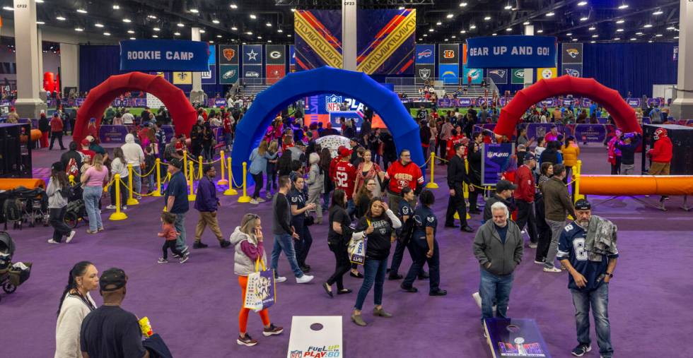 Fans walk about the Super Bowl Experience at the Mandalay Bay Convention Center on Wednesday, F ...