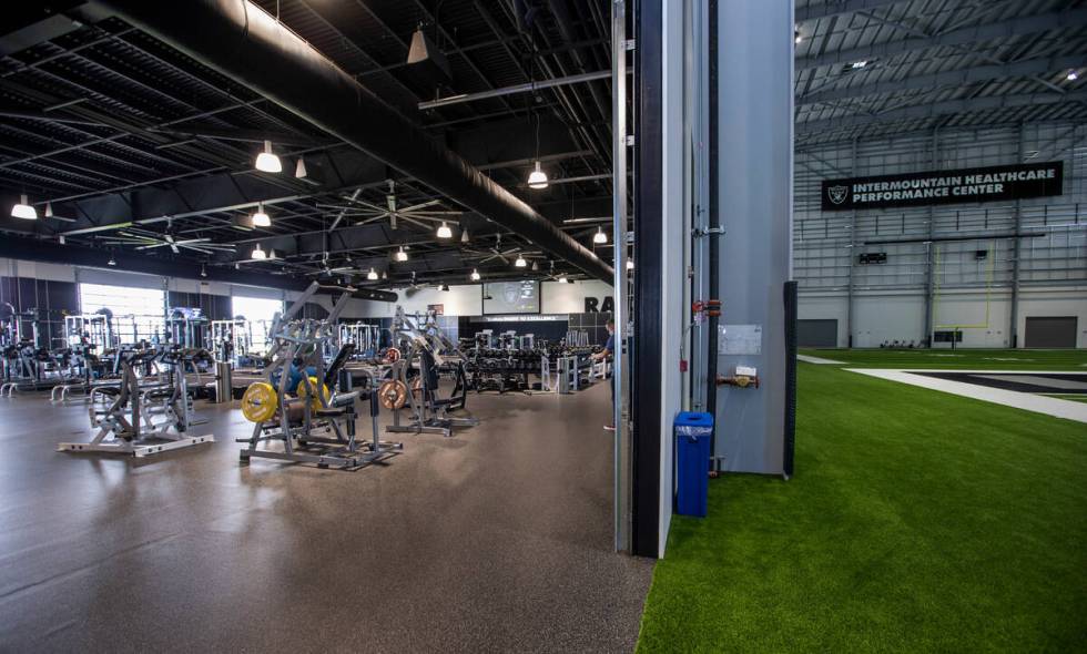 A large weight room opens to the indoor practice field within the Intermountain Healthcare Perf ...