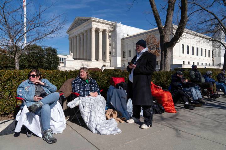 People wait in line outside of the U.S. Supreme Court to have a place in the upcoming hearing o ...