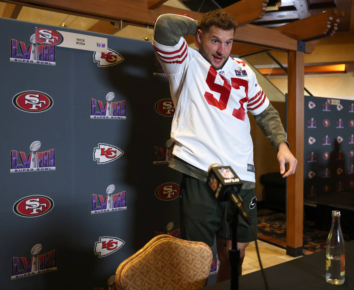 San Francisco 49ers defensive lineman Nick Bosa dons his jersey before talking with the news me ...