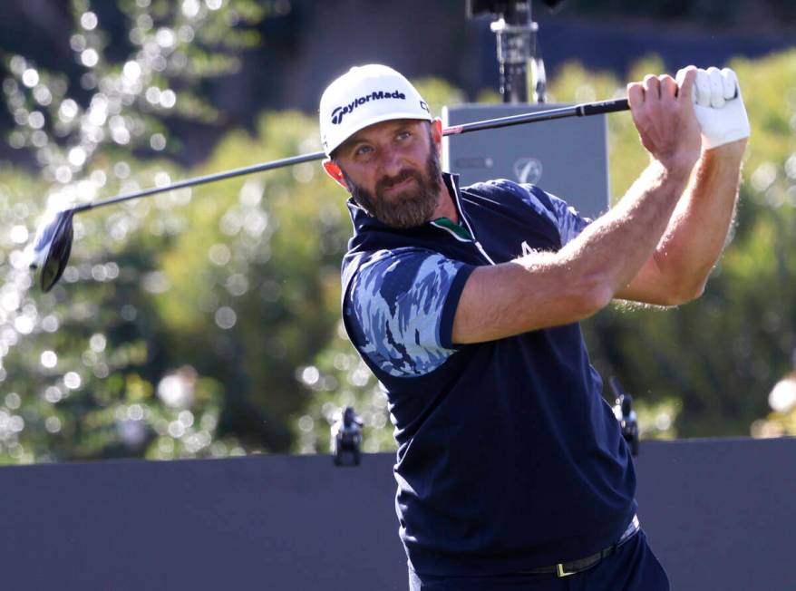 Dustin Johnson of team Aces GC watches his drive off the tee during the first round of LIV Golf ...