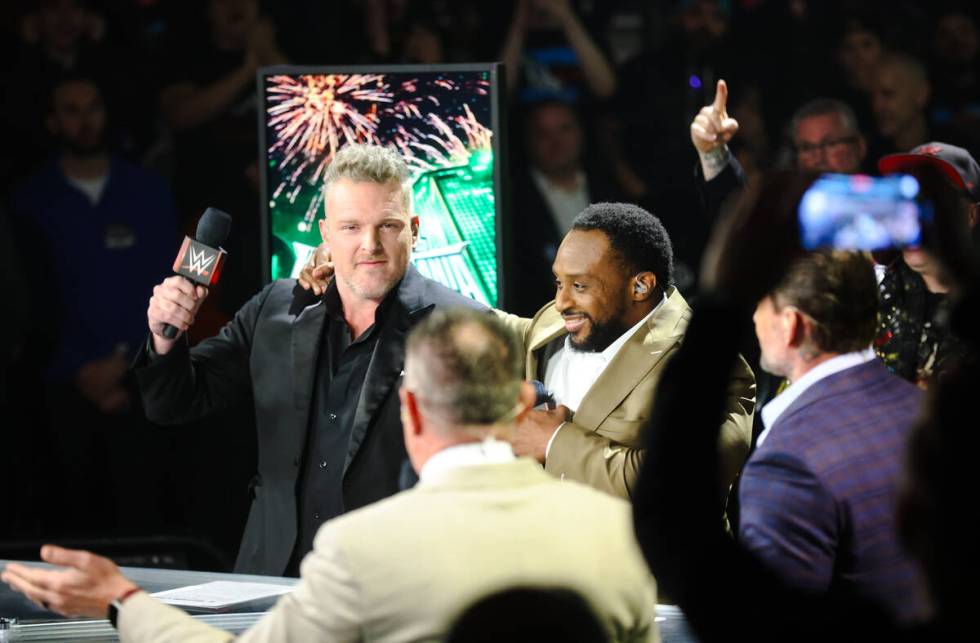 Pat McAfee, left, and pro wrestler Big E embrace as they host a press conference for WrestleMan ...