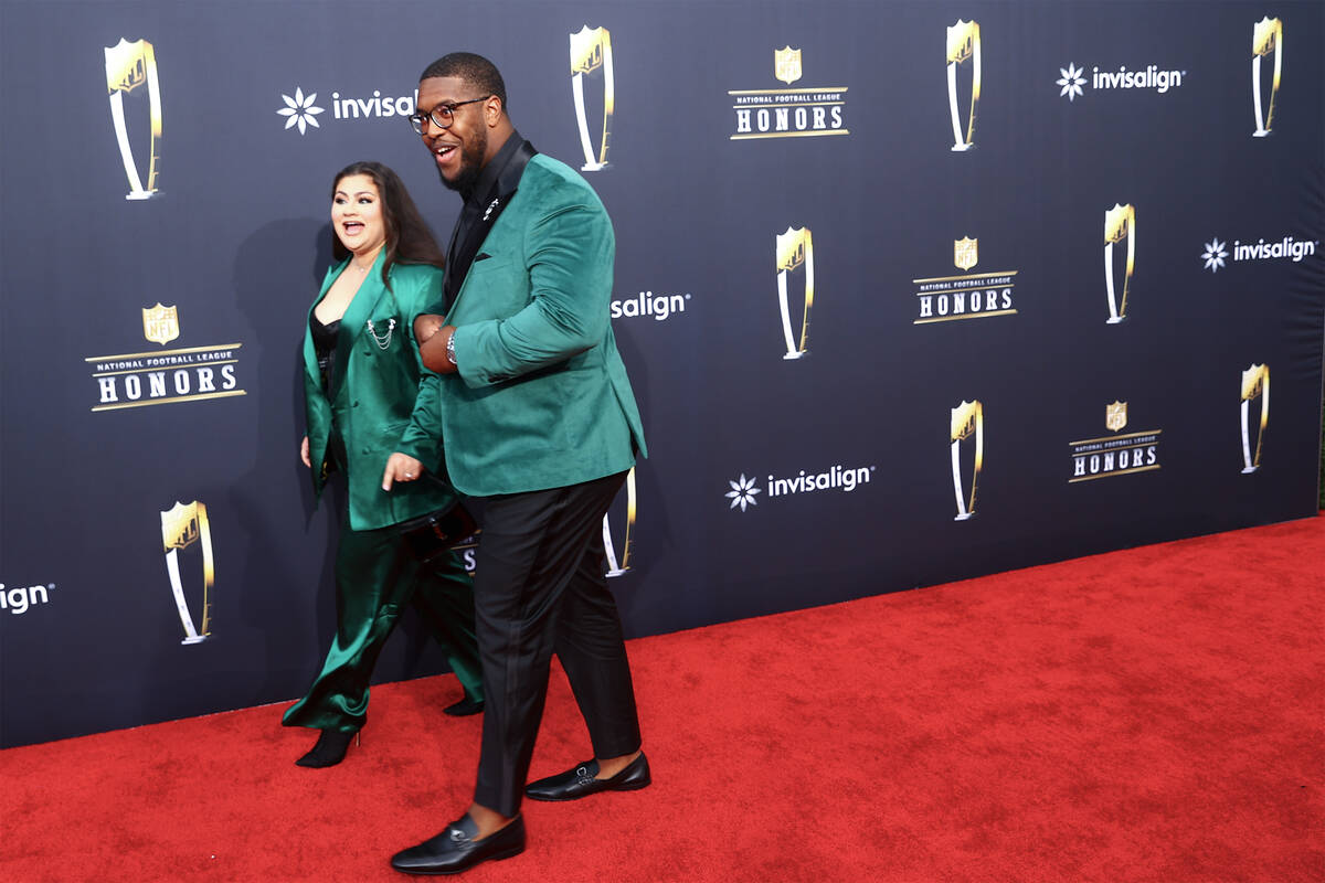 Los Angeles Rams defensive tackle Kobie Turner walks on the red carpet with his fiancee Alissa ...
