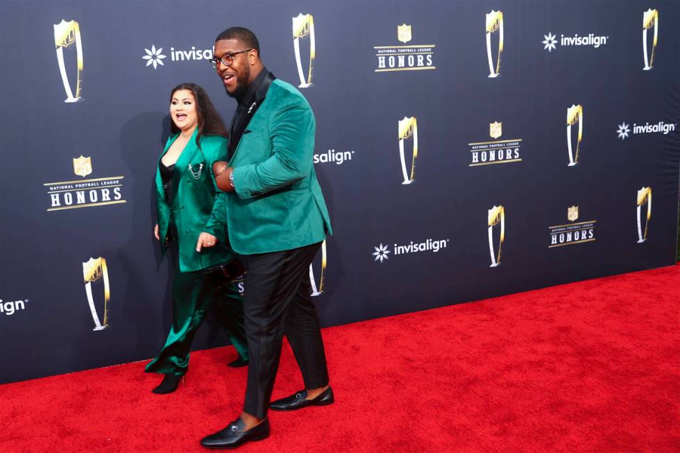 Los Angeles Rams defensive tackle Kobie Turner walks on the red carpet with his fiancee Alissa ...