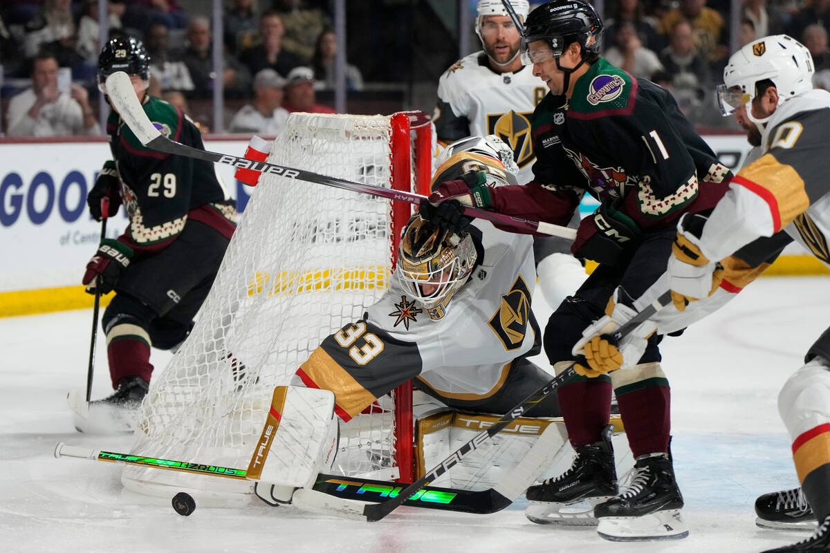 Vegas Golden Knights goaltender Adin Hill (33) makes a save on Arizona Coyotes right wing Dylan ...