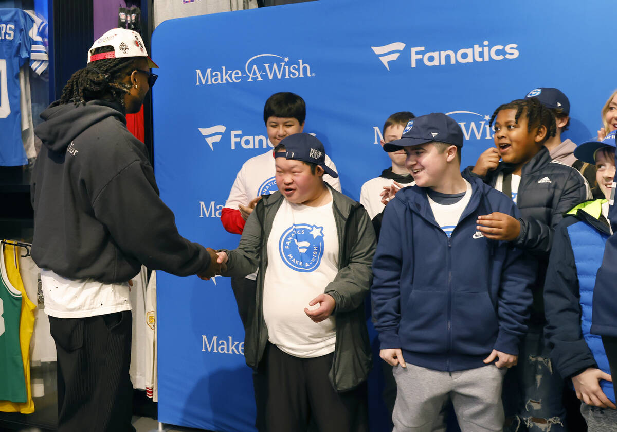 Make-A-Wish kids react as Raiders wide receiver Davante Adams arrives at the Lids Flagship Stor ...