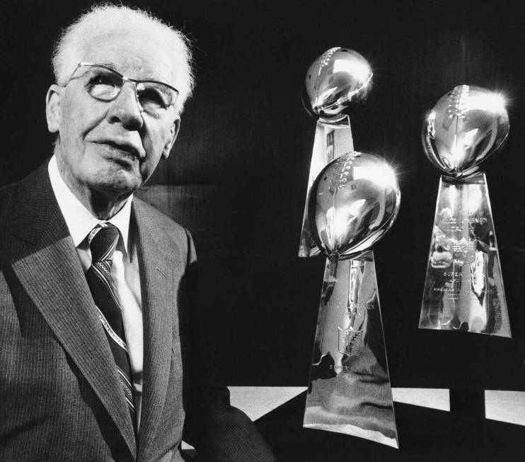 Art Rooney, Sr., owner of the Pittsburgh Steelers poses with his team's three Super Bowl Trophi ...