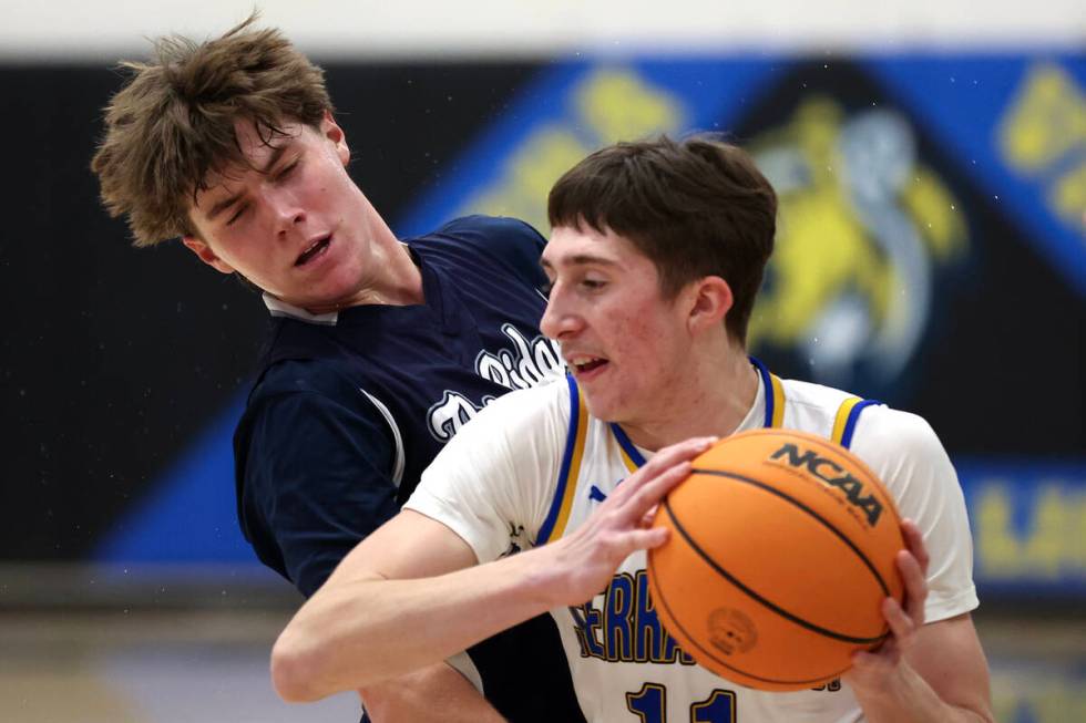 Sierra Vista forward Ethan Nelson (11) muscles around Shadow Ridge guard Brock Morrow (24) duri ...