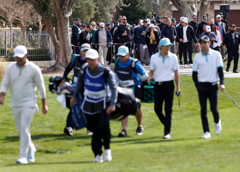 Fans follow players during the second round of LIV Golf Las Vegas tournament at Las Vegas Count ...