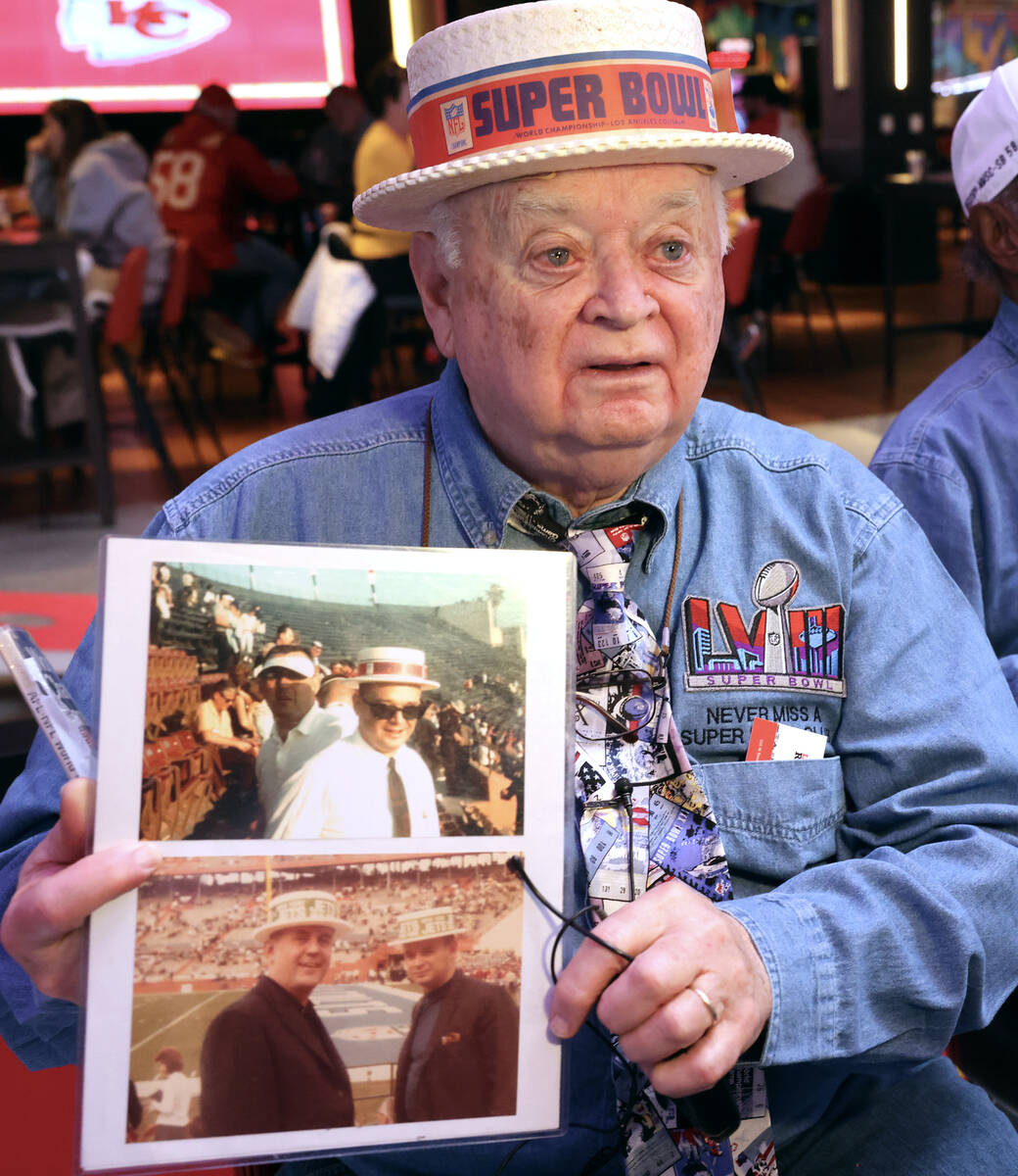 Don Crisman, 87, a member of the Never Miss a Super Bowl Club, shows a hat and program from the ...