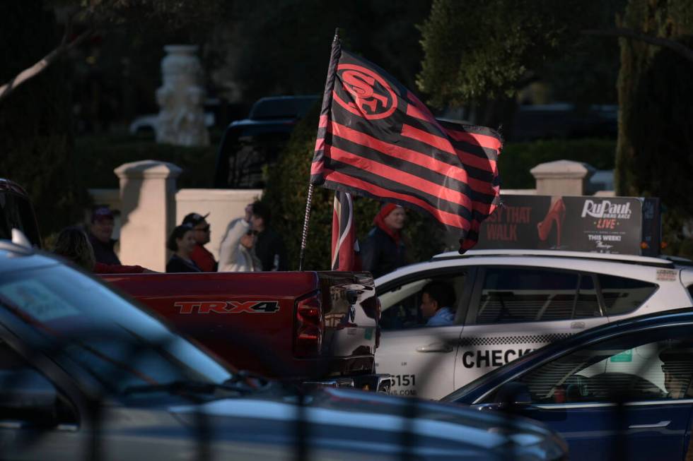 A truck carries a San Francisco 49ers flag on the Strip the day before Super Bowl LVIII Saturda ...