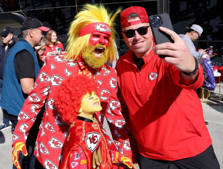 A Chiefs fan, poses with Rick Draper and his son Hoyt Draper, 8, outside Allegiant Stadium in L ...