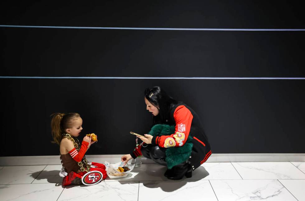 People snack on food during the first half of Super Bowl 58 at Allegiant Stadium on Sunday, Feb ...