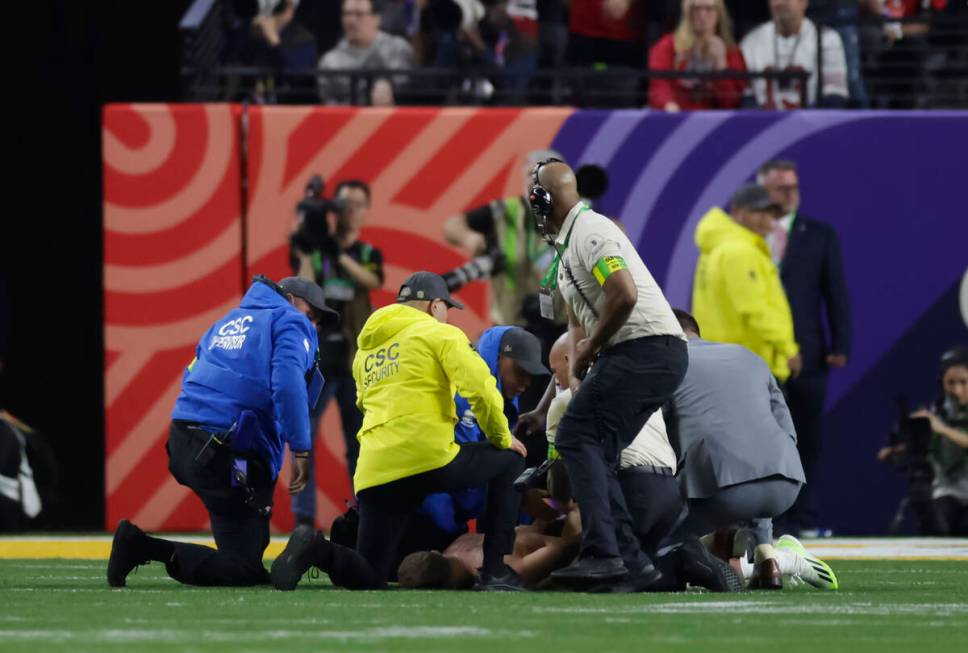 A man who ran onto the field is stopped by security during the second half of Super Bowl 58 bet ...