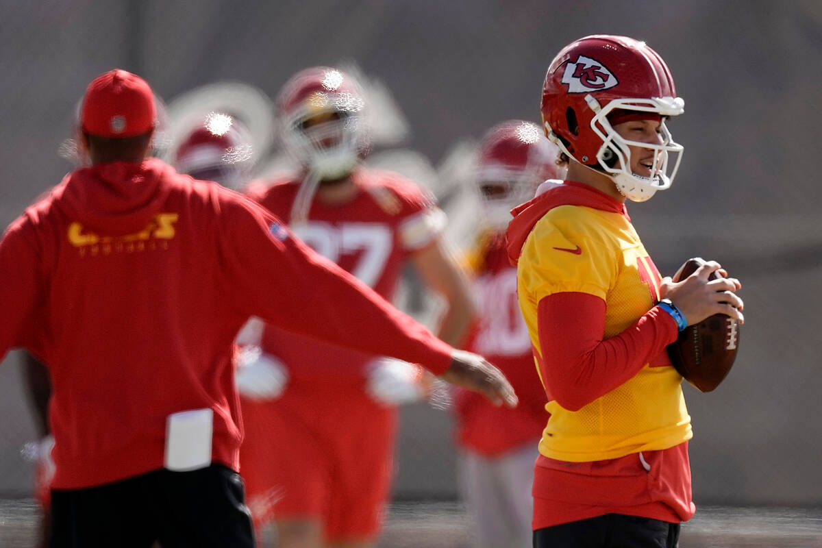 Kansas City Chiefs quarterback Patrick Mahomes, right, waits to start a drill during practice f ...