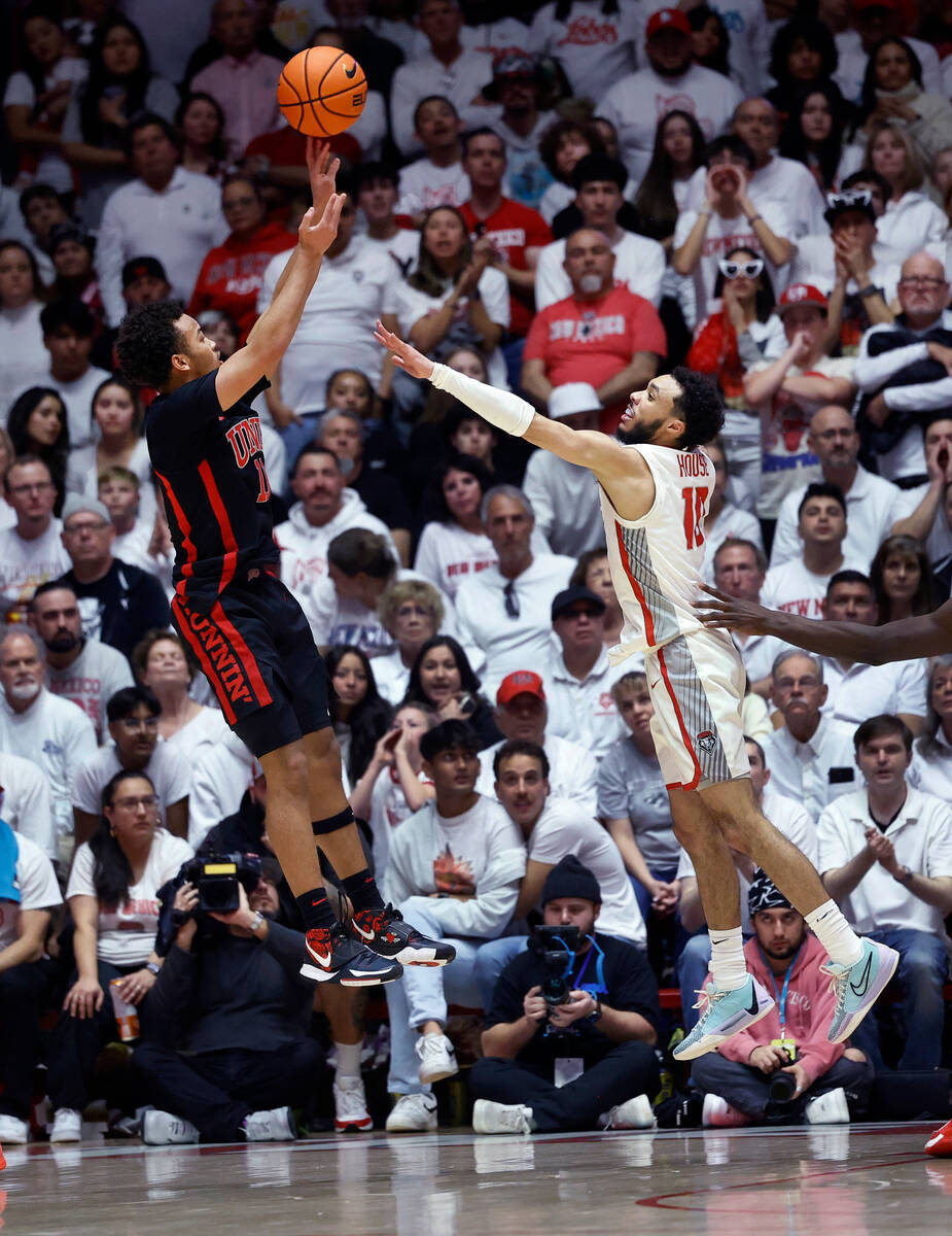 UNLV guard Dedan Thomas Jr. shoots a 3-pointer as New Mexico guard Jaelen House defends during ...