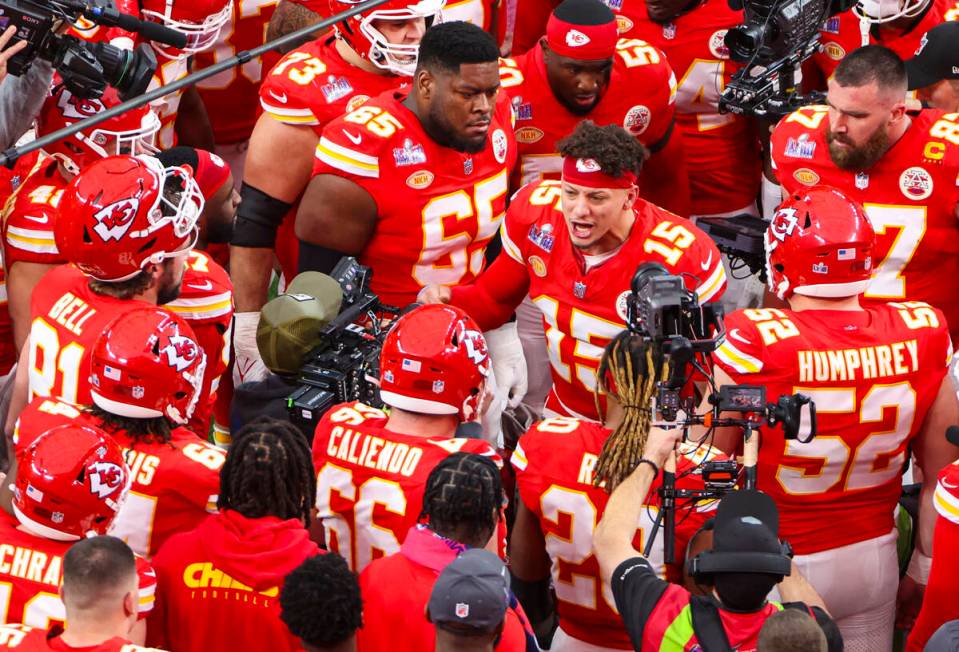 Kansas City Chiefs quarterback Patrick Mahomes (15) huddles with teammates before the start of ...