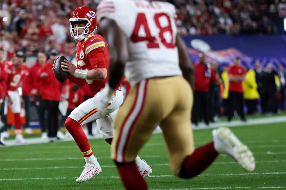 Kansas City Chiefs quarterback Patrick Mahomes (15) rolls out of the pocket during the second h ...