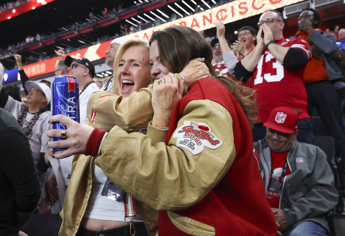 San Francisco 49ers fans hug during the first half of Super Bowl 58 against the Kansas City Chi ...