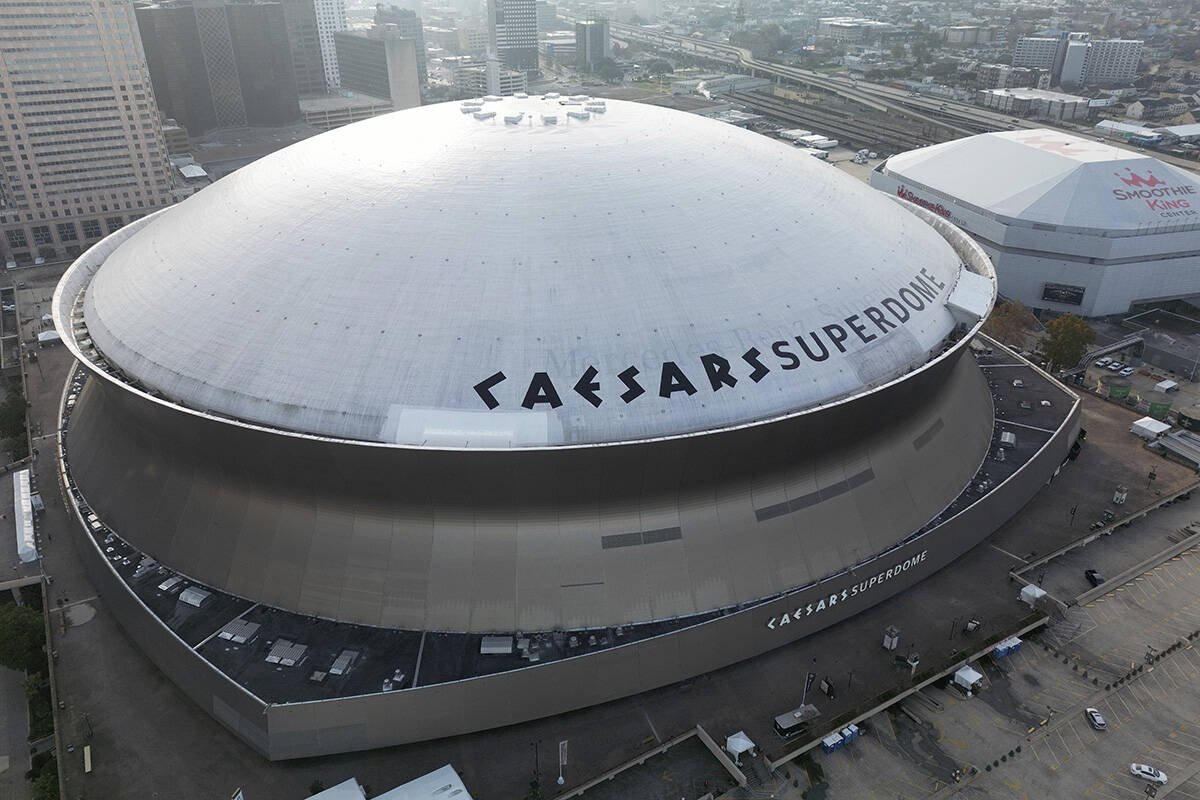 An aerial overall exterior general view of Caesars Superdome with the New Orleans skyline in th ...