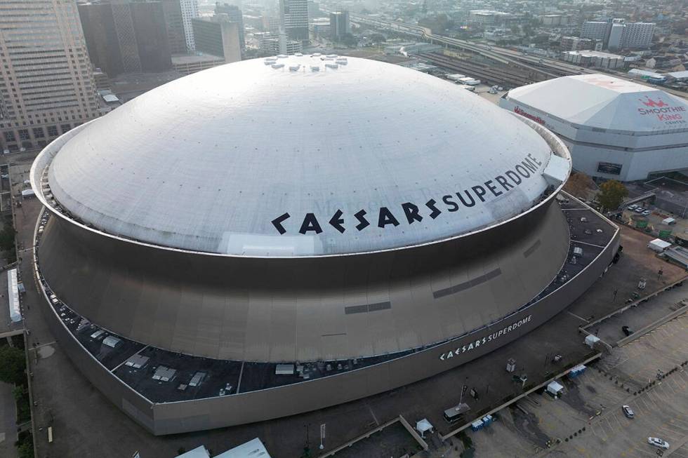 An aerial overall exterior general view of Caesars Superdome with the New Orleans skyline in th ...