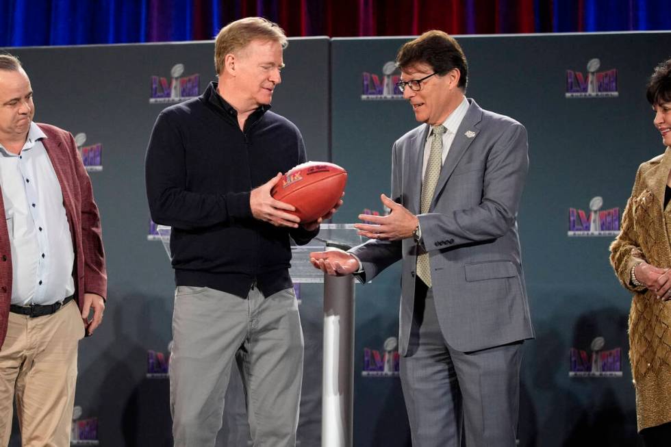 NFL Commissioner Roger Goodell, left, hands off a ball to Jay Cicero, president and CEO of the ...