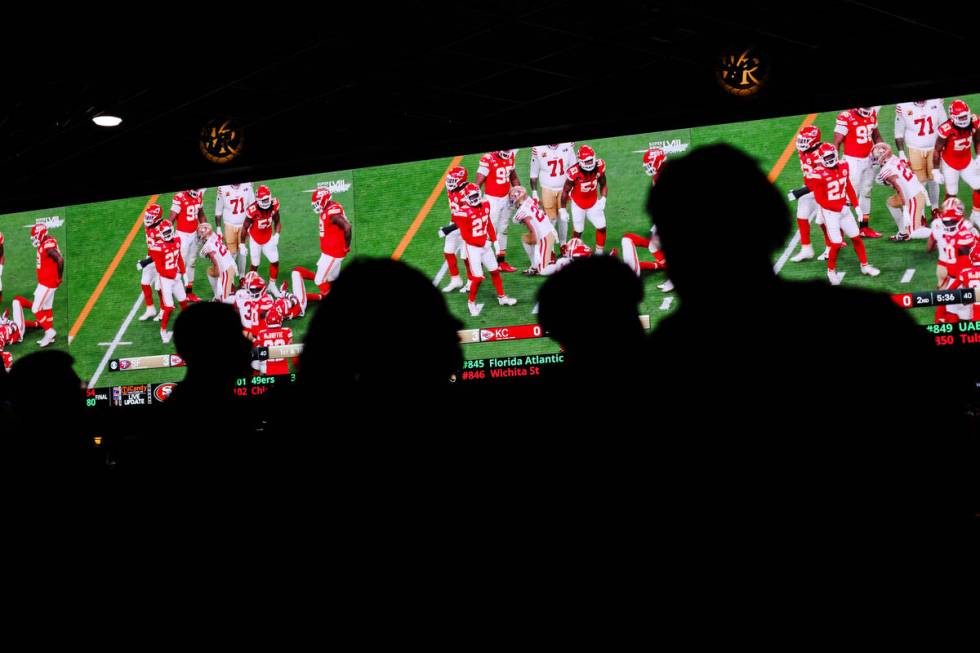 Fans watch the Kansas City Chiefs face off the San Francisco 49ers for Super Bowl LVIII at West ...