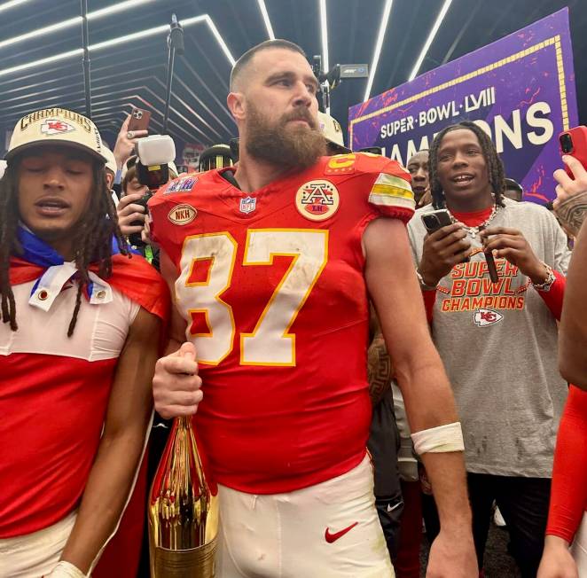 Kansas City Chiefs tight end Travis Kelce celebrates in the team's locker room at Allegiant Sta ...