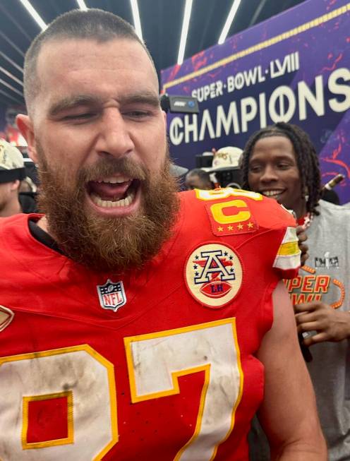 Kansas City Chiefs tight end Travis Kelce celebrates in the team's locker room at Allegiant Sta ...