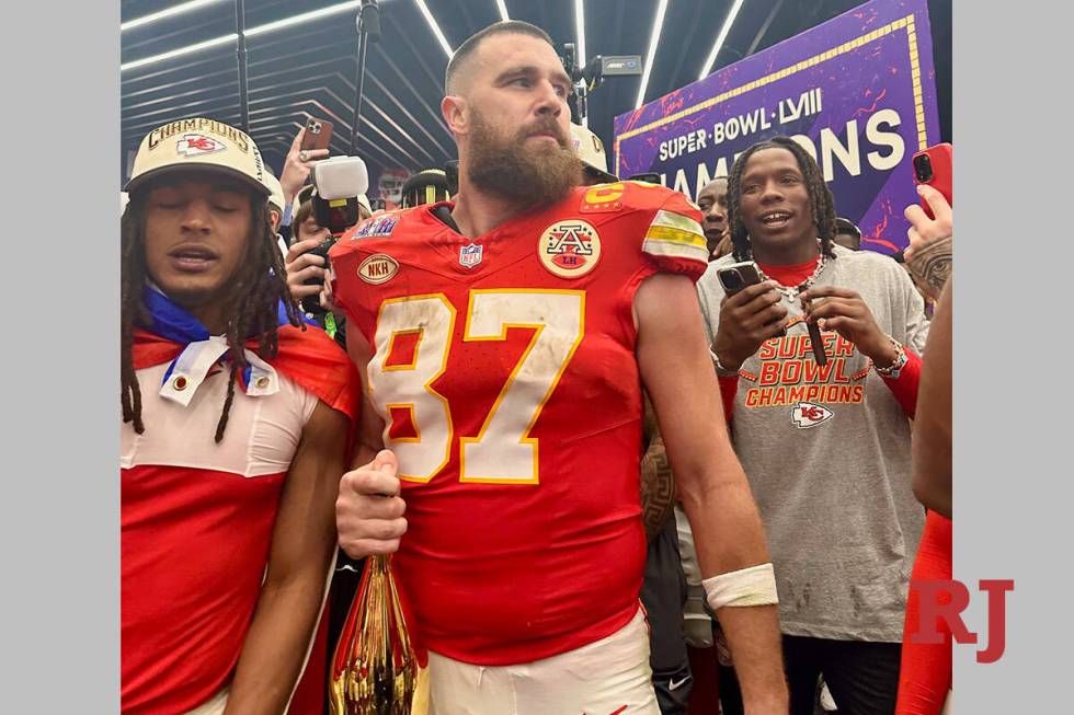 Kansas City Chiefs tight end Travis Kelce celebrates in the team's locker room at Allegiant Sta ...