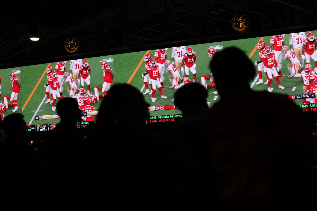 Fans watch the Kansas City Chiefs face off the San Francisco 49ers for Super Bowl LVIII at West ...