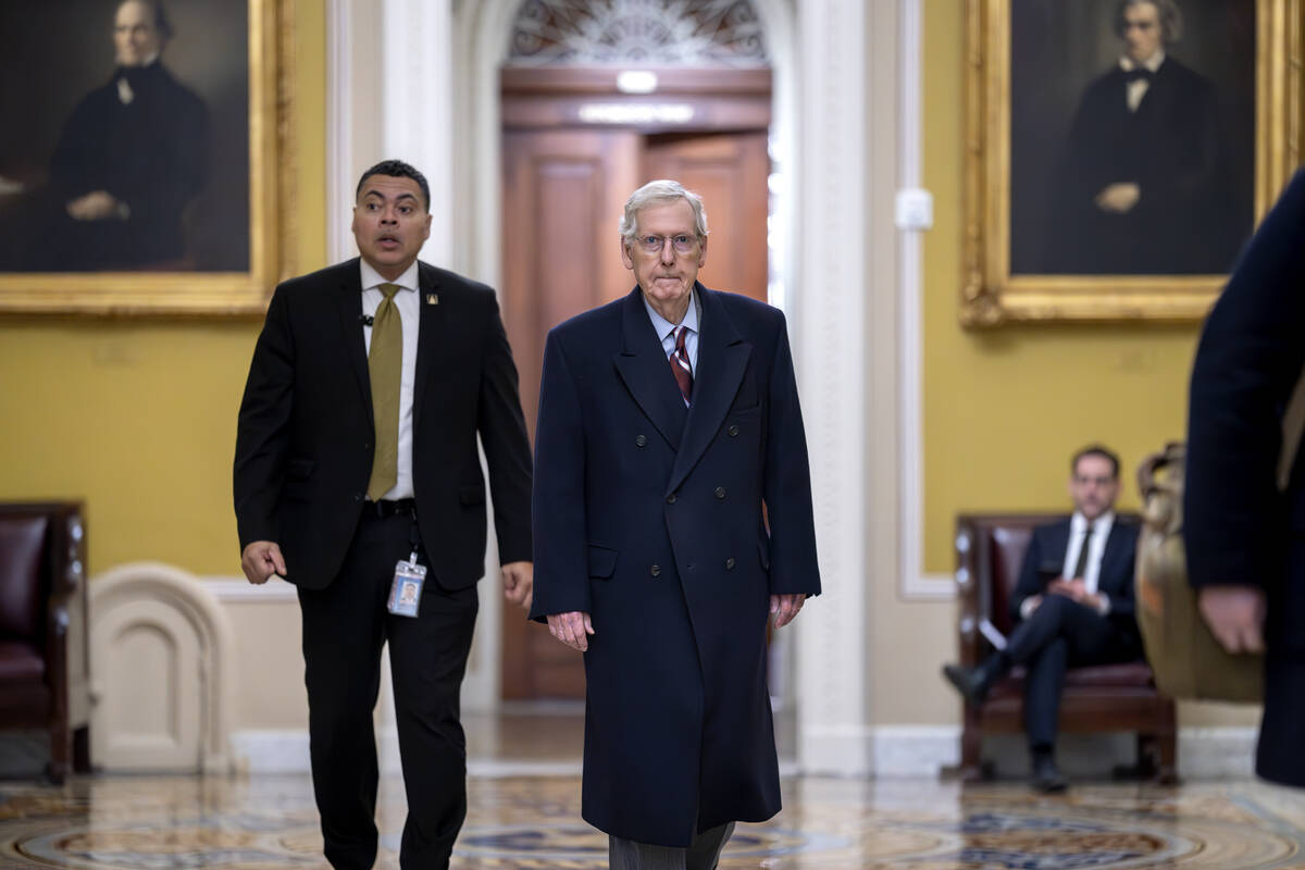 Senate Minority Leader Mitch McConnell, R-Ky., right, arrives as the Senate moves closer to a f ...