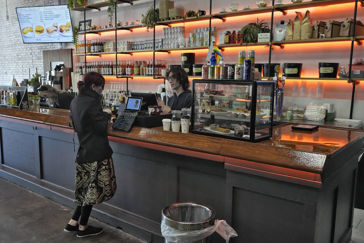 FILE - A customer buys a cup of coffee at the Blind Tiger Cafe on Jan. 10, 2024, in Tampa, Fla. ...