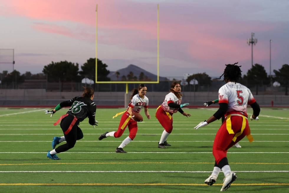 Las Vegas quarterback Sarah Pasquali (6) runs th ball against Palo Verde during a Class 5A stat ...