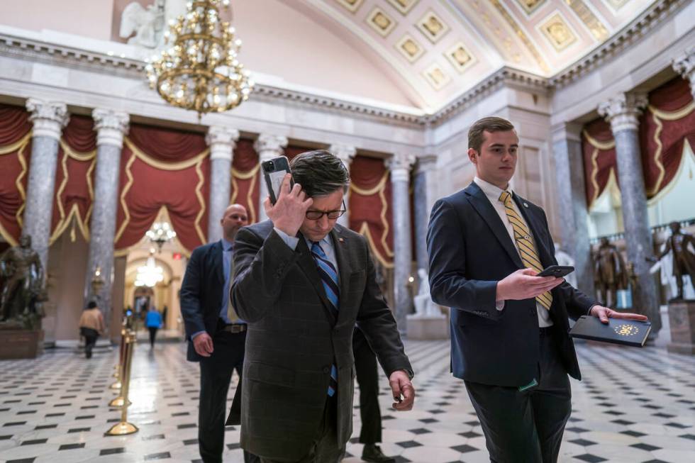 House Speaker Mike Johnson, R-La., walks through Statuary Hall as lawmakers gather in the House ...