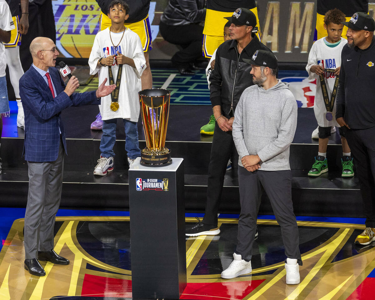 NBA Commissioner Adam Silver, left, awards the wining trophy to the Los Angeles Lakers after de ...