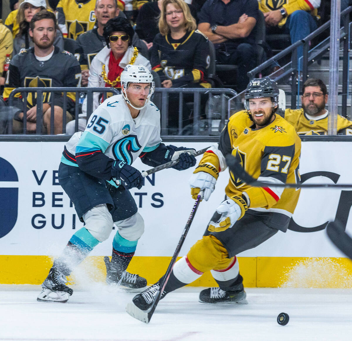 Golden Knights defenseman Shea Theodore (27) looks to the puck with Seattle Kraken left wing An ...