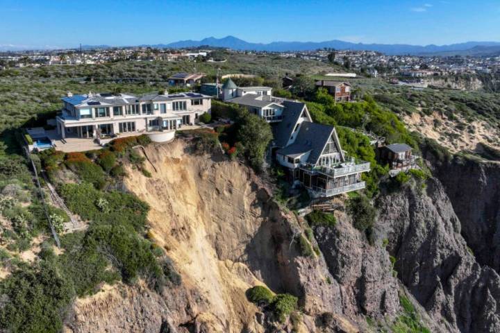 Cliff-top houses along Scenic Drive sit close to a landslide in Dana Point, Calif., on Tuesday, ...