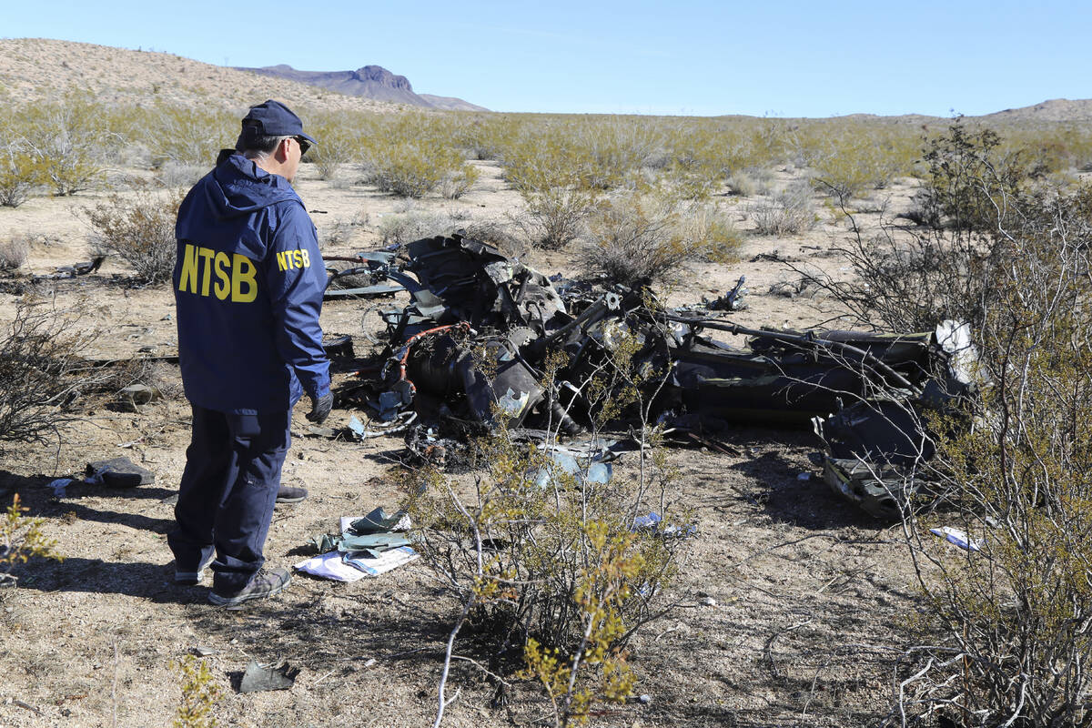 An NTSB investigator surveys the site of an Airbus Helicopters EC-130 on Sunday, Feb. 11, 2024, ...