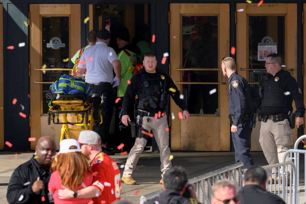 Emergency personnel, left, take a stretcher into Union Station following a shooting at the Kans ...