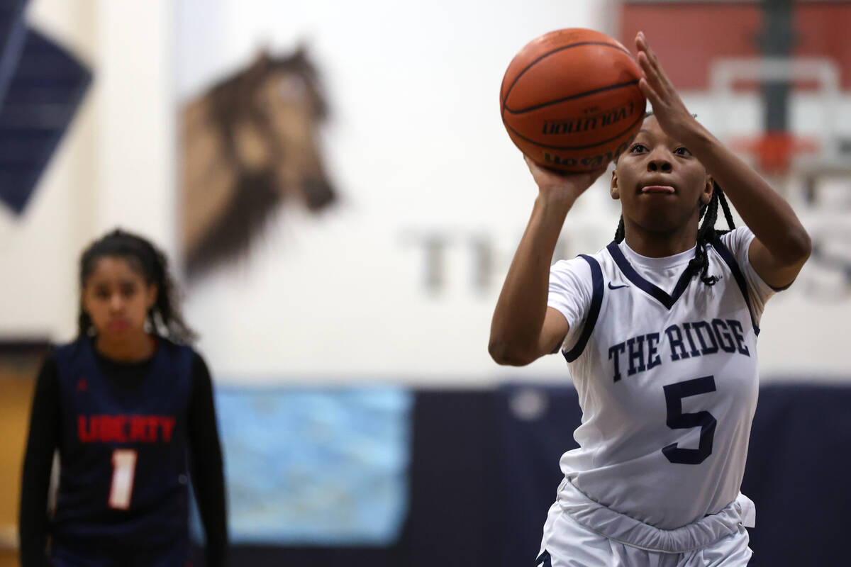 Shadow Ridge guard Zh'mya Martin (5) clinches an overtime win at the free throw line during a C ...