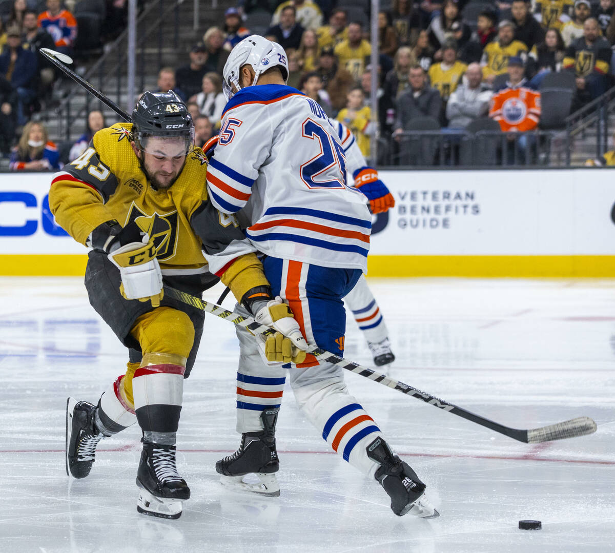 Golden Knights center Paul Cotter (43) is checked by Edmonton Oilers defenseman Darnell Nurse ( ...