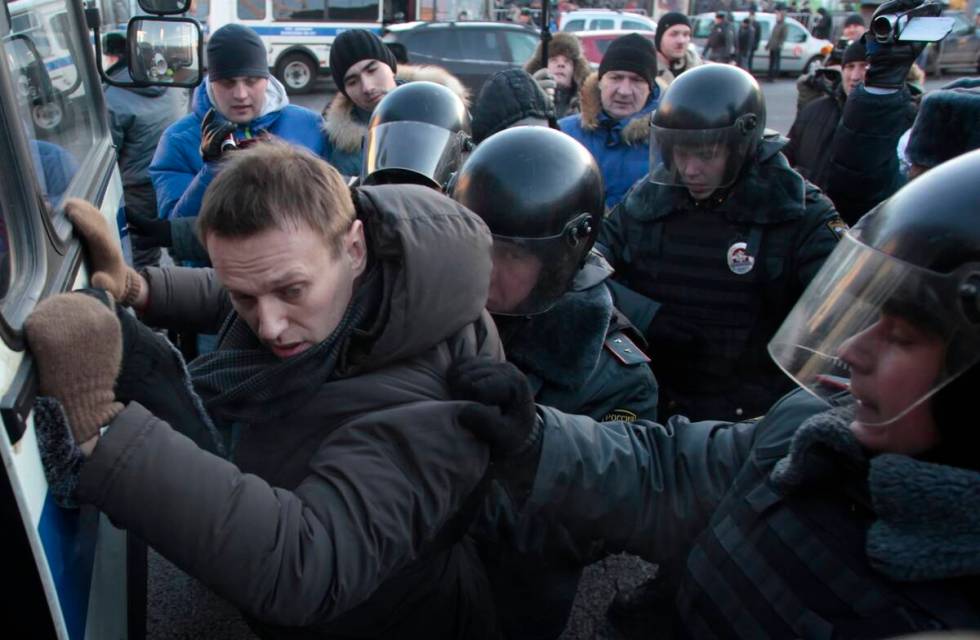 FILE - Police officers detain opposition leader Alexei Navalny during an unauthorized rally in ...